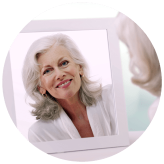 Lady smiling into a mirror