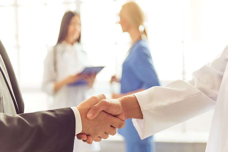 Failing implants Dr shaking hands with patient