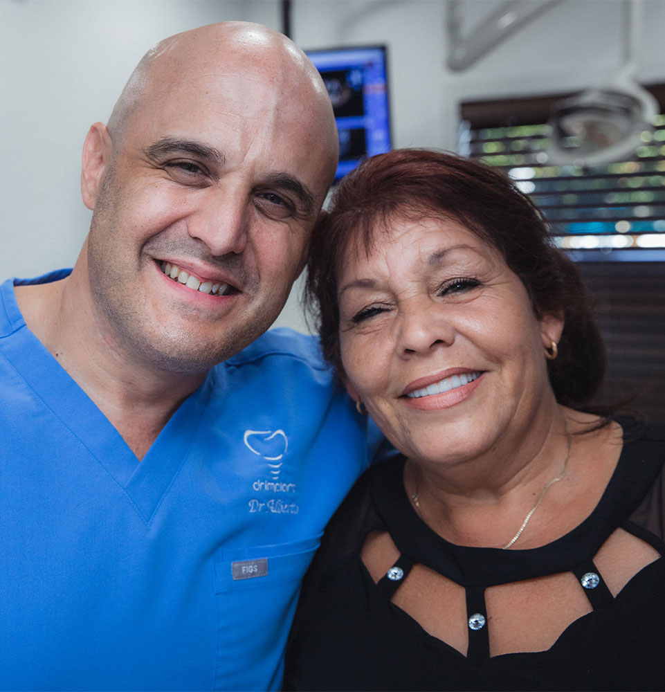 dental patient smiling with dr. alberto